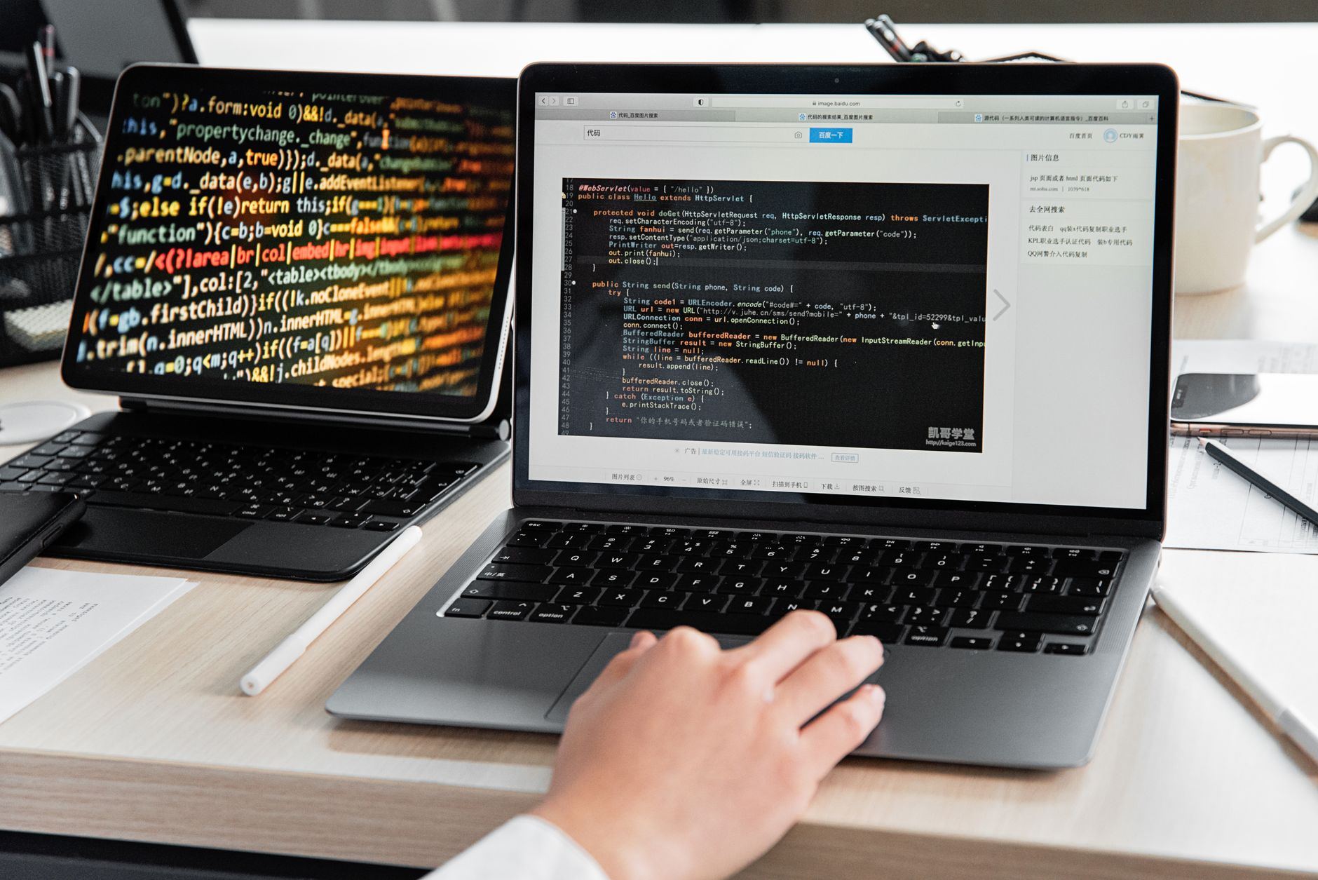 A developer writing code on a laptop