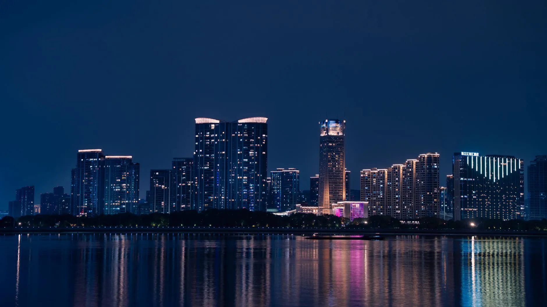 Stunning night view of the Hangzhou skyline reflected in the Qiantang River.