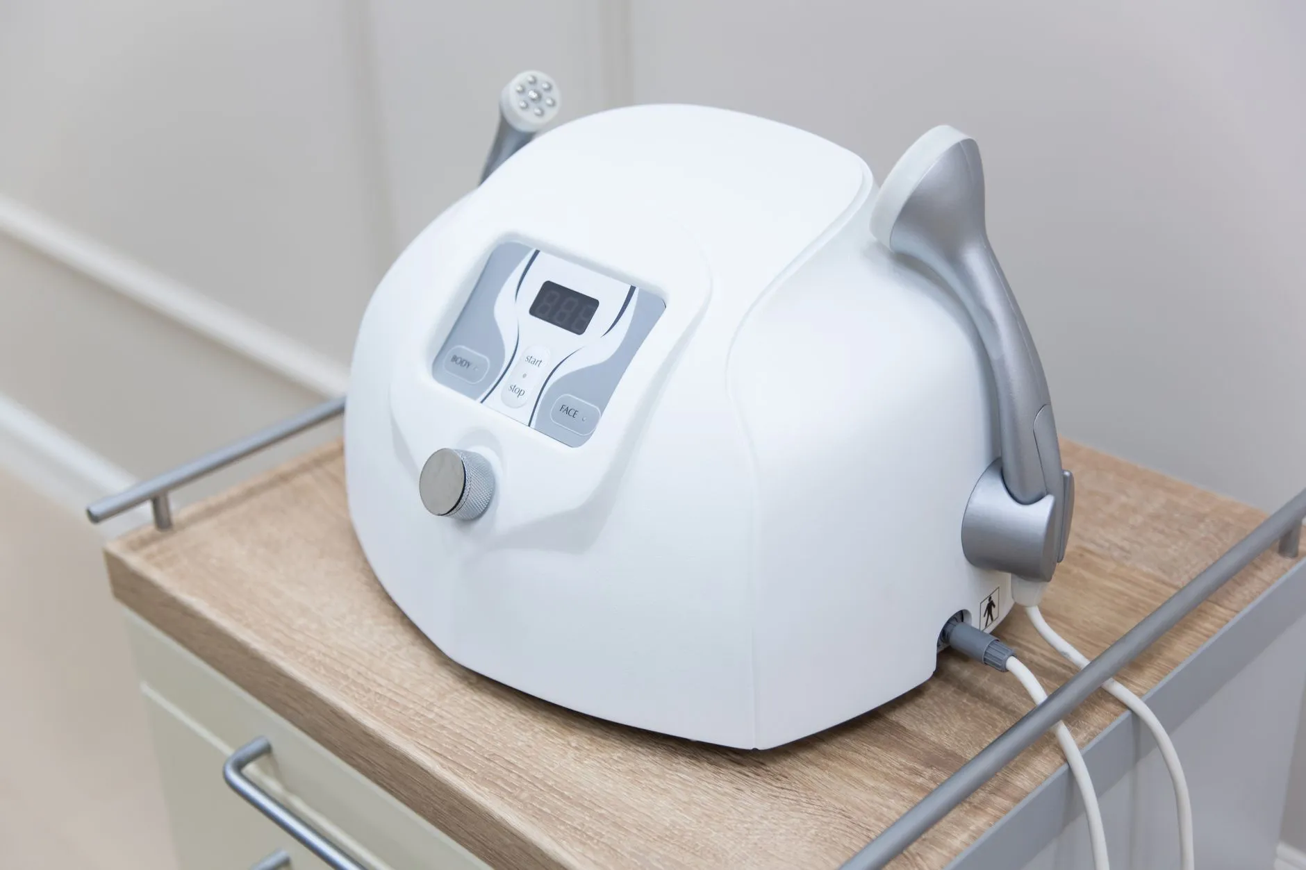 Close-up of a modern medical face massager on a sterile cabinet, essential for healthcare settings.