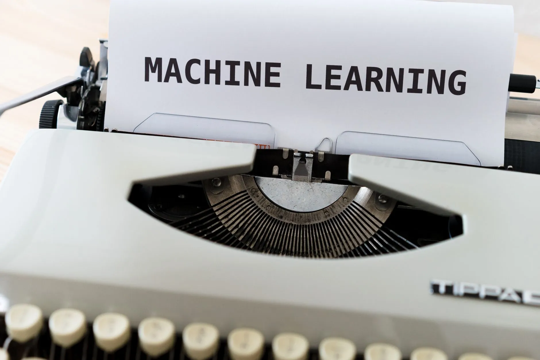 Vintage typewriter displaying 'Machine Learning' text, blending old and new concepts.